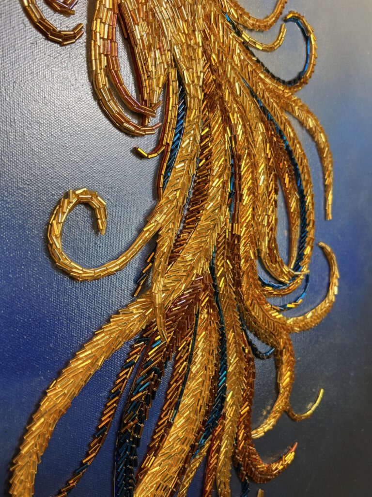 Close-up of BECOMING showing dense directional beadwork in the Phoenix tail.